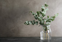 Bunch Of Eucalyptus Branches With Fresh Leaves In Vase On Table