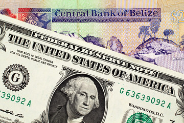 American one dollar bill with a colorful two Belize dollar bank note