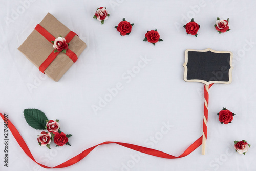 Brown Gift Box And Tiny Blackboard Decorate With Red Rose Paper