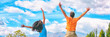Happy people jumping of fun enjoying travel adventure. Young couple from behind happiness jump banner panorama in blue sky.