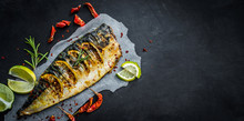 Grilled Mackerel Fish With Lime On A Black Background, Copy Space Fried Fish And Vegetables