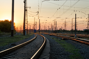 Railway pointwork, railway tracks on the station at summer sunset. Transportation