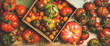 Flat-lay of fresh colorful ripe Fall or Summer heirloom, bunch and cherry tomatoes veriety over rustic wooden background, top view. Local market seasonal produce