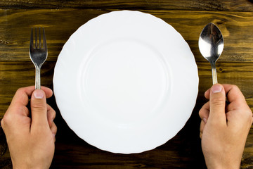 Color plates on wooden table background