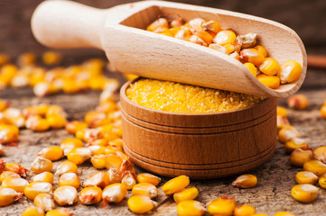 a bowl of corn is on a wooden table