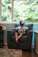 Boy Using Virtual Reality Headset In Living Room