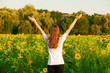 © Svetlana - Young woman with long hair in sunflower Field with hands up. Beauty girl outdoors enjoying nature