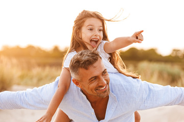 Wall Mural - Cheerful father spending fun time with his little daughter