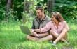 © be free - Modern technologies give opportunity to be online and work in any environment conditions. Man and girl looking at laptop screen. Freelance opportunity. Couple youth spend leisure outdoors with laptop