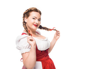 Wall Mural - smiling oktoberfest waitress in traditional bavarian dress with pigtails isolated on white background