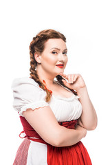 Wall Mural - smiling oktoberfest waitress in traditional bavarian dress looking at camera isolated on white background