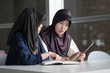 © 9nong - back to school with serious muslim woman college students; portrait of islamic woman students with hijab studying hard in college level education, back to school concept; asian young adult woman model