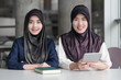 © 9nong - muslim woman college students getting back to school; portrait of happy smiling islamic woman students studying in college education; fall, winter back to school concept; asian young adult woman model