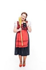 Wall Mural - happy oktoberfest waitress in traditional german dress holding wheat and mug of brown beer isolated on white background