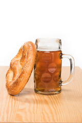 Wall Mural - selective focus of beer with pretzel on wooden table on white background