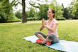 © Syda Productions - fitness, yoga and healthy lifestyle concept - happy woman meditating in summer park