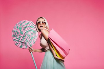 model posing with with sweets and shopping bags