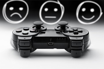 Joystick with face icon on grey background