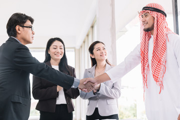 Arab businessmen relationship with American businessmen Confirm of a partnership as well.Arab Business concept,Handshake.