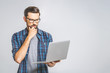 © denis_vermenko - Confident business expert. Confident young handsome man in shirt holding laptop while standing against white background