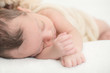 © Simon Dannhauer - Cute newborn baby sleeping on a blanket - happy family moments concept