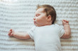 © kaloriya - Cute infant child sleeping on white sheets