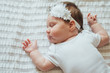 © kaloriya - Cute infant child sleeping on white sheets