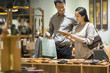 © Blue Jean Images - Happy young couple shopping in leather shop