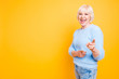 Portrait of confident modern granny pointing two index fingers a