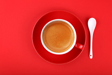 Wall Mural - Full cup of espresso coffee on red paper