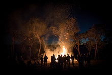 A Large Group Of People Gathering Around A Bonfire