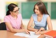 © BillionPhotos.com - Two young female students studying in library