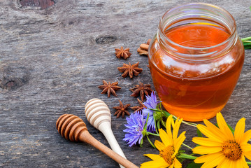 Honey in jar with honey spoon