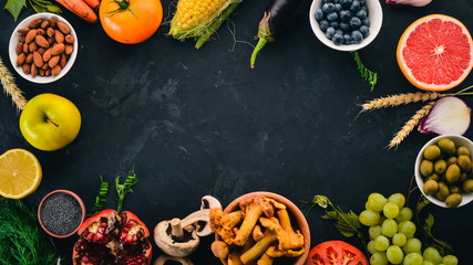 Food. Vegetables, fruits, nuts and berries. Healthy food. On the stone table. Top view. Free space for text.