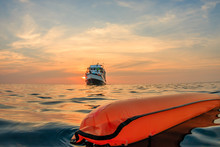 A Surface Marker Buoy And Dive Boat On The Surface Of A Warm Tropical Ocean At Sunset