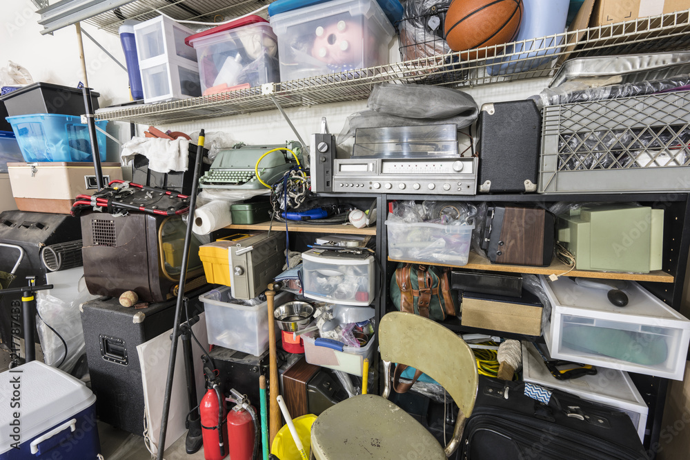 Full shelves of vintage electronics, boxes and sports equipment in typical suburban garage. - obrazy, fototapety, plakaty 