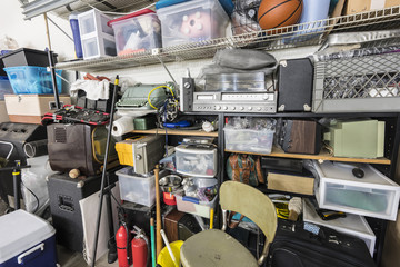 Wall Mural - Full shelves of vintage electronics, boxes and sports equipment in typical suburban garage.