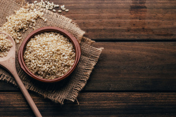 Full container with brown rice, rustic style