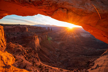 Cliff's-edge Sandstone Mesa Arch Framing An Iconic Sunrise View Of The Red Rock Canyon Landscape Below.