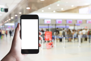 Woman passenger hand holding empty screen of smart phone and check-in counter airport terminal background.