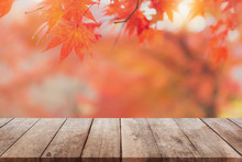 Empty Wood Table Top And Blurred Autumn Tree And Red Leaf Background - Can Used For Display Or Montage Your Products.