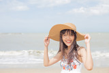 Fototapeta Boho - Thai girl enjoy and happy her relaxing on the beach, Hua Hin, Thailand
