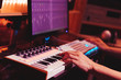 © princeoflove - musician hands playing midi keyboard synthesizer for recording music on computer in digital sound studio