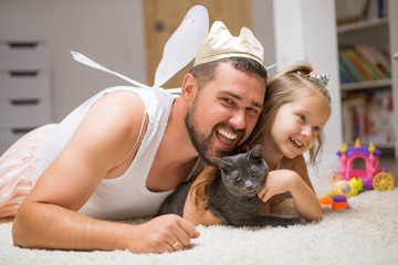 Little daughter and father have fun, dressing in princess costume, daddy makeup