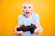 Blond hair granny hold joystick in her hands a play at video gam