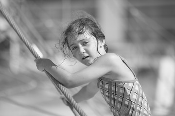 Girl 6 years old on a rope attraction on the beach