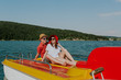 © Newman Studio - Cheerful man and woman having fun while boating. Portrait of couple in love enjoying being together on pedal boat on warm sunny day.
