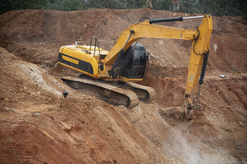 Wall Mural - Excavator drilling on top of rocks at foundation infrastructure construction site