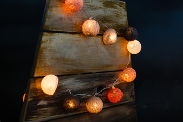 Canvas Print - Christmas garland in the form of large colored balls on a black background.