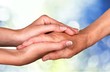 © BillionPhotos.com - Female and male hands holding each other on background